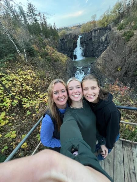 Drei Mädels machen ein Selfi vor dem Wasserfall.
