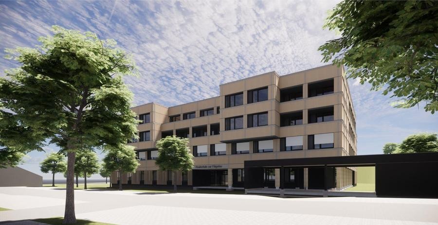 Ein Schulgebäude, davor ein Platz mit Bäumen