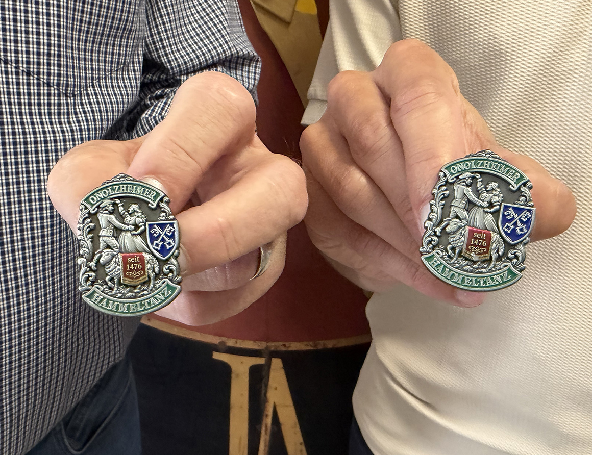 zwei Hände, die jeweils eine Plakette halten