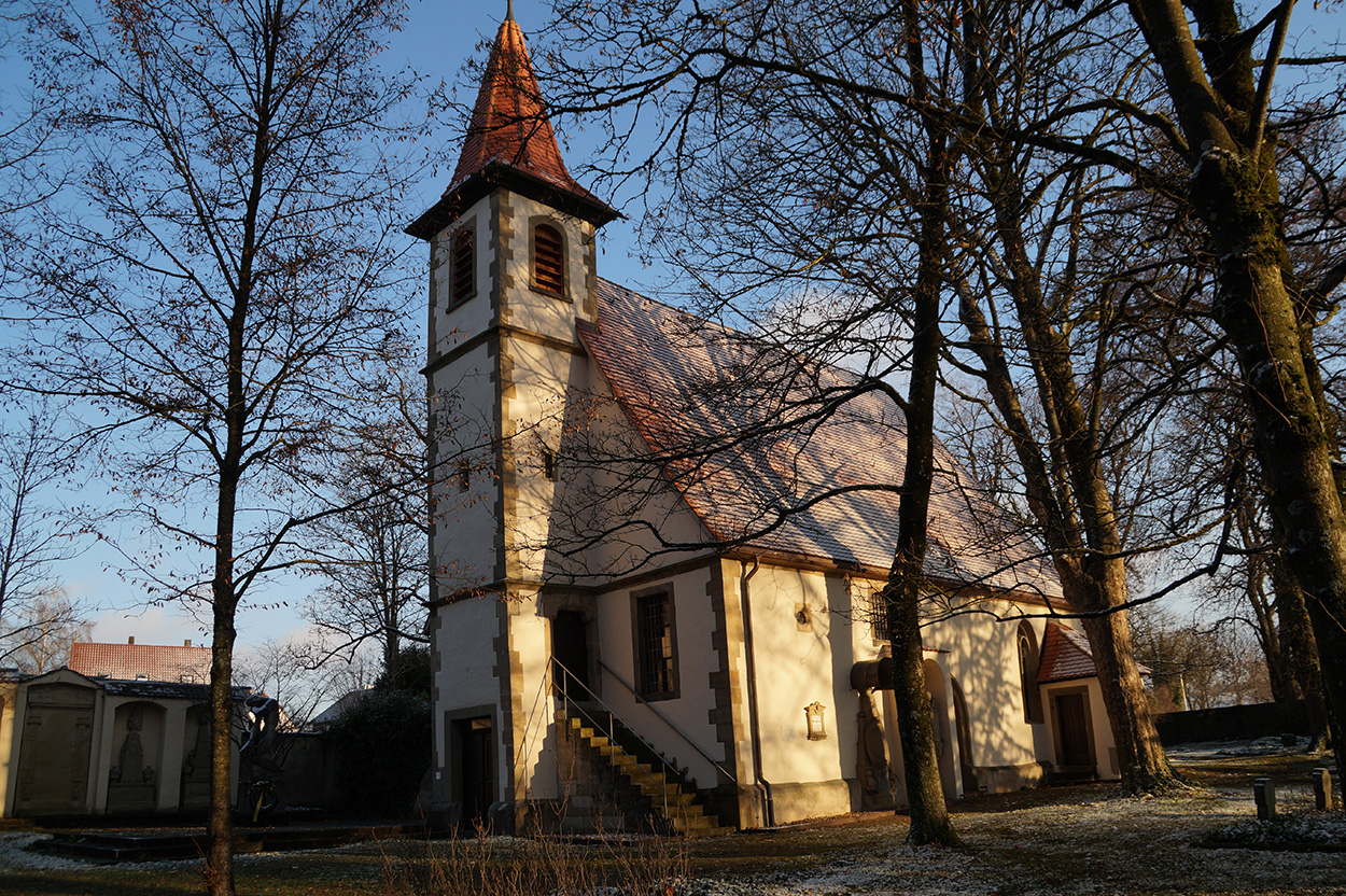 Eine Kapelle inmitten eines Friedhofs mit Bäumen